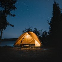 Barraca iluminada sob o céu estrelado.
